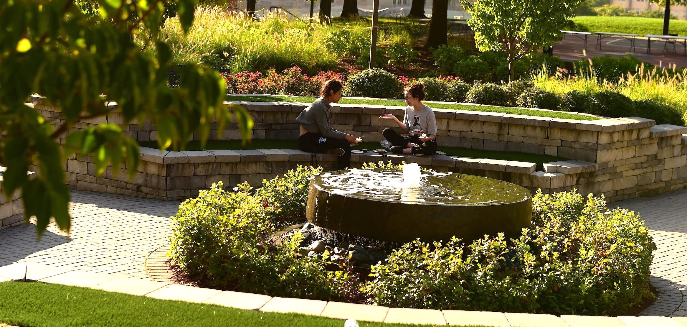 Centennial Village with students and flowers in front